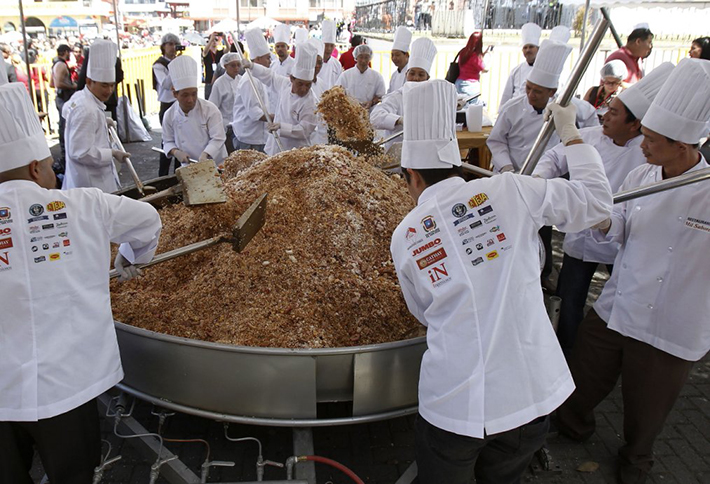 Chinese residents in Costa Rica cook Cantonese fried rice during Chinese Lunar New Year celebrations in Chinatown in San Jose